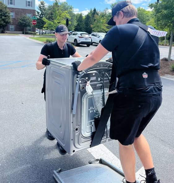 Arnold Brothers movers loading a carefully strapped appliance