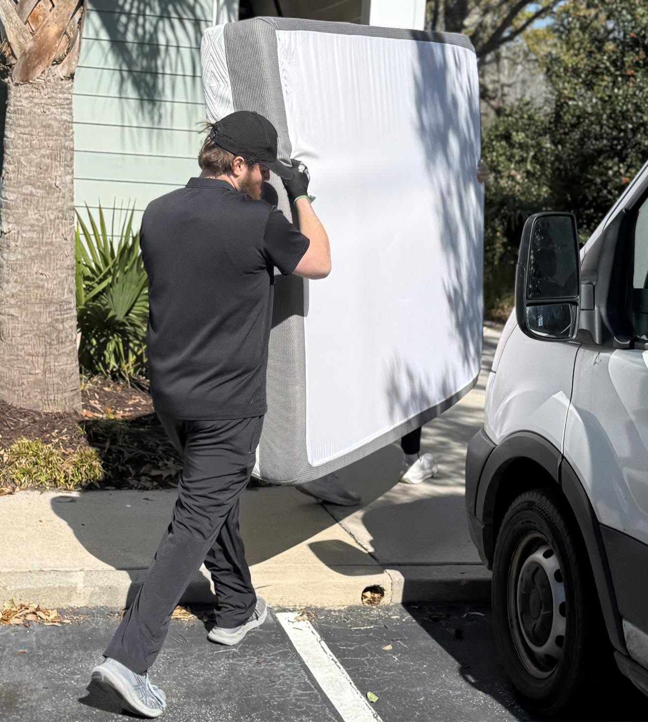 Arnold Brothers movers carrying a protected mattress during an apartment move