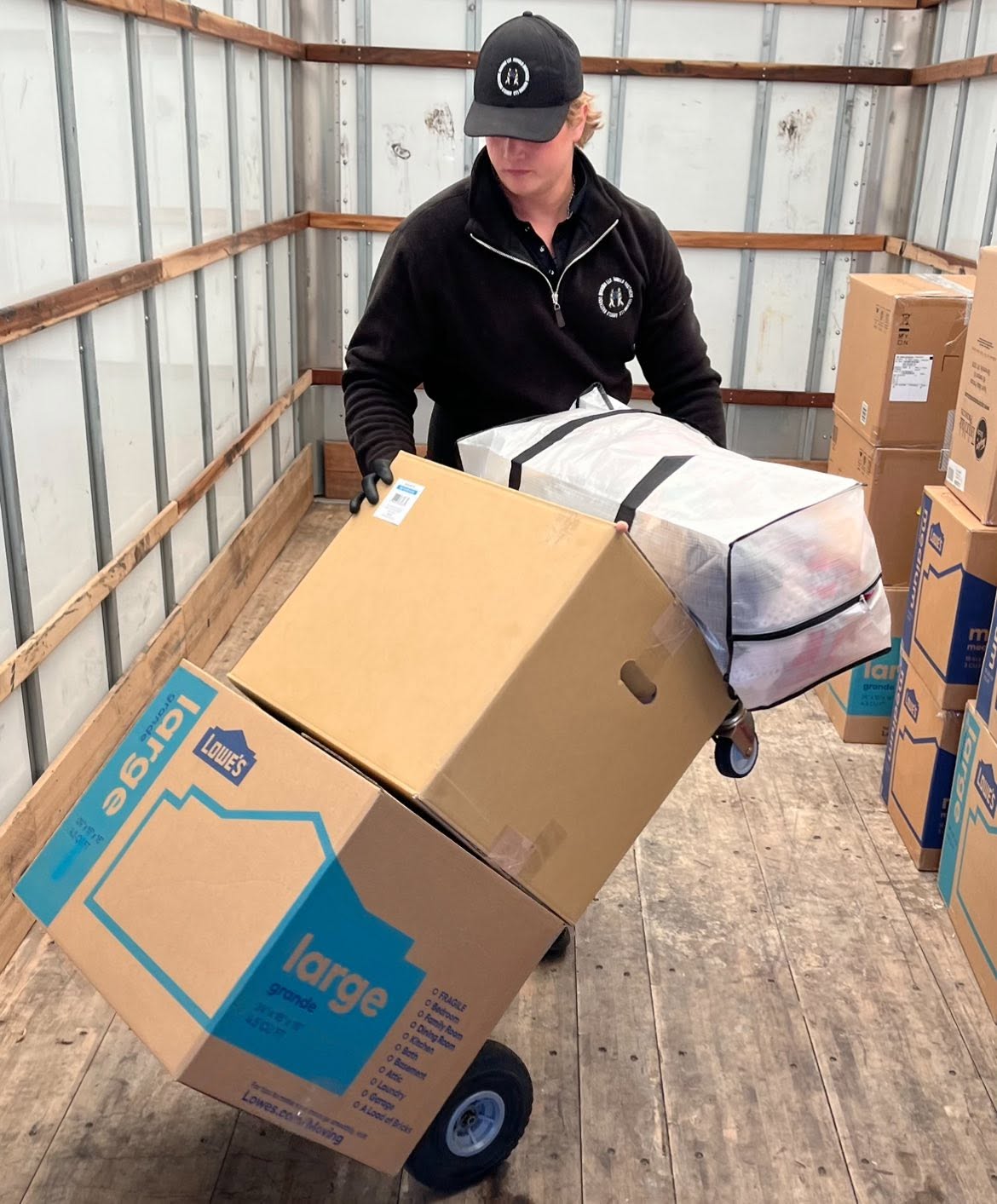 Arnold Brothers mover loading packed boxes on a hand truck