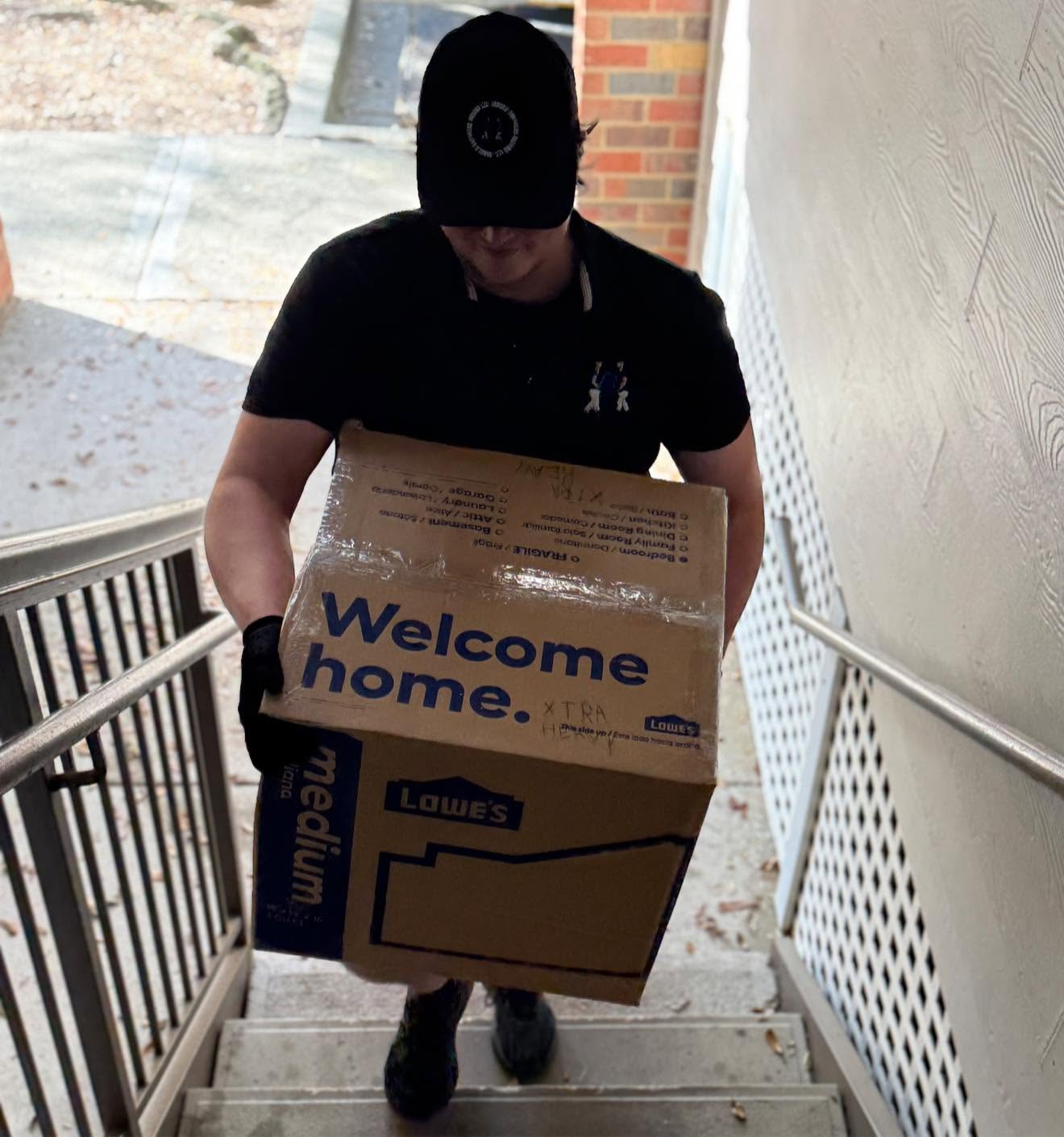 Arnold Brothers mover carrying packed boxes to a new home