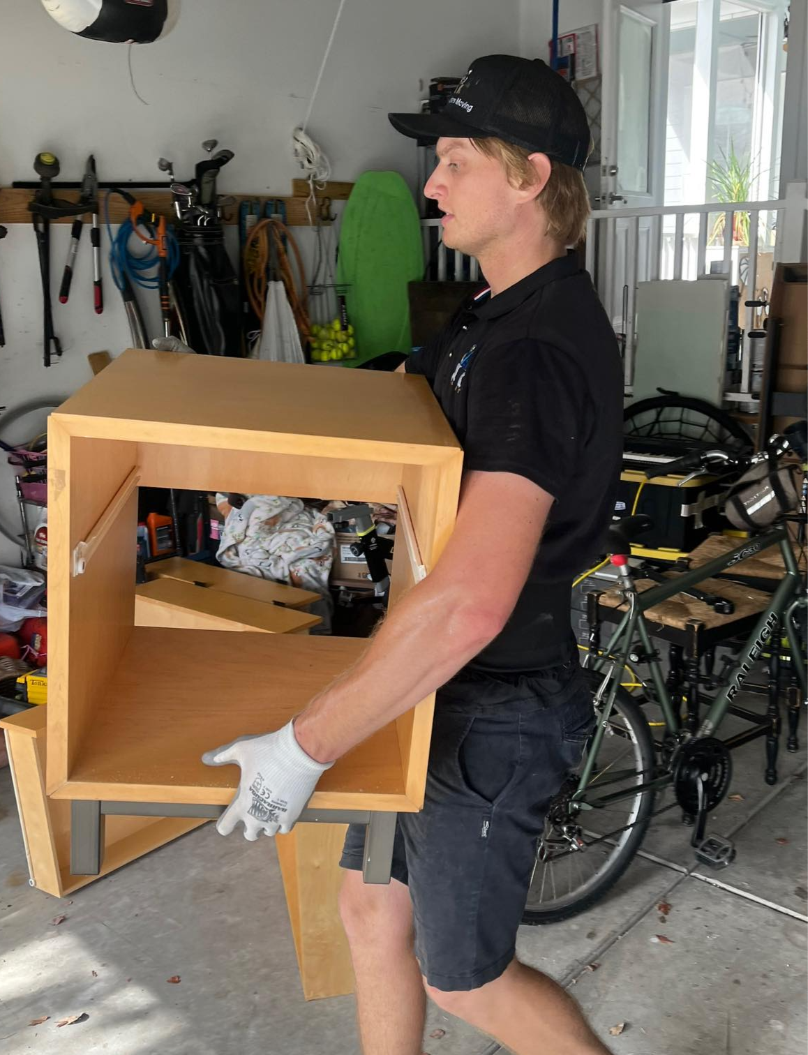 Arnold Brothers mover carrying a large furniture item